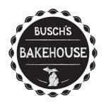 Black circular logo with a scalloped edge, featuring "Busch's Bakehouse" in white, chalk-like text. Below is an outline of Michigan, adding regional touch.