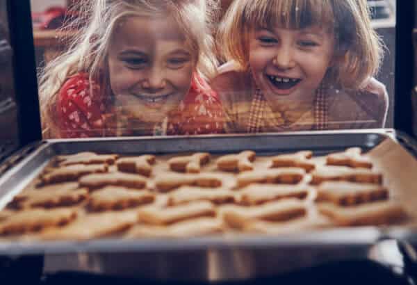 Children are looking at cookies baking in the oven in  Ann Arbor, Michigan