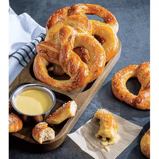 Overhead picture of Copycat Jumbo Soft Pretzels with Honey-Mustard Dip on a plate.