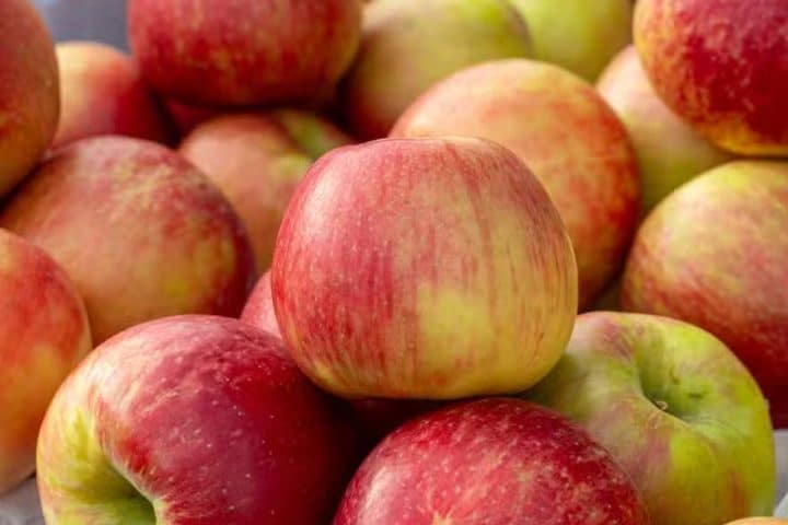 Fresh red and yellow apples stacked in baskets at a market in Ann Arbor, MI
