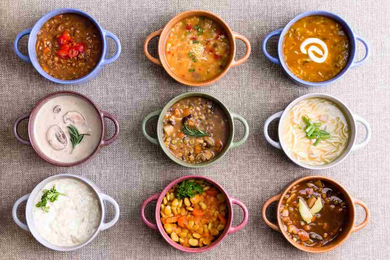 Assorted colorful bowls of soups arranged in a grid for a meal display in Ann Arbor, MI