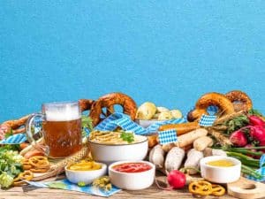 Oktoberfest spread with pretzels, sausages, dips, and beer on a table in Ann Arbor, MI