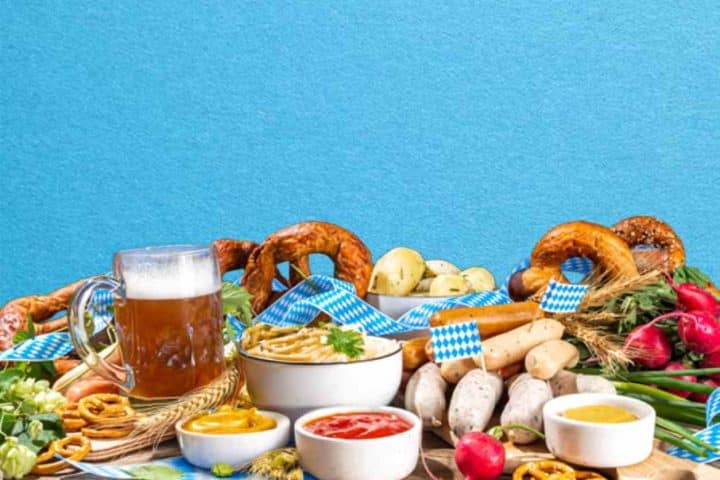 Oktoberfest spread with pretzels, sausages, dips, and beer on a table in Ann Arbor, MI